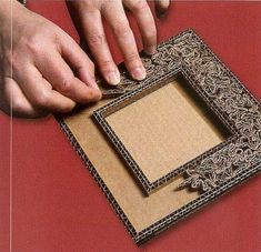 two hands reaching for an empty box on a red surface