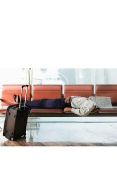 a man sleeping on a bench with his luggage