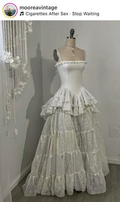 a white dress on display in front of a mannequin