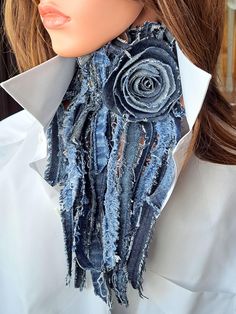 a close up of a mannequin wearing a blue scarf with flowers on it