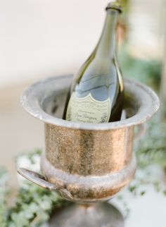 a bottle of wine in a silver cup