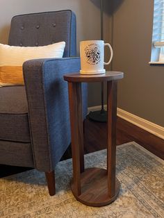 a table with a coffee cup on it next to a couch