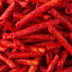 a pile of red food sitting on top of a table