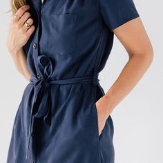 Without a doubt, the classic shirt dress is one of the most versatile garments a woman can own. This dress fits in at the most casual of establishments, but can transition easily to a fancier night out. Not too tight, not too loose, and made of a wonderfully soft and supple tencel fabric, our Shirt Dress is the first and last place our most discerning clientele looks. This item will be discontinued. Future orders will require a 50 piece MOQ. Features: Button Up Front, 20L Custom Engraved Corozo Collared Midi Dress With Placket, Fitted Shirt Dress With Tie Waist For Day Out, Classic Dress With Rolled Sleeves, Fitted Collared Shirt Dress With Tie Waist, Date Night Shirt Dress With Short Sleeves And Buttons, Mid-length Shirt Dress For Daywear, Mid-length Shirt Dress For Day Out, Daywear Dress With Spread Collar, Collared Neckline Relaxed Fit Dress For Work