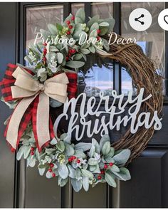 a christmas wreath with the words merry christmas on it and a bow hanging from the front door