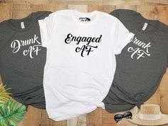 three t - shirts with the words engaged off on them next to a hat and sunglasses