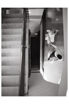 black and white photograph of a person on an escalator