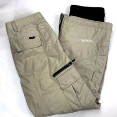 OBERMEYER Exhibition Cargo Snowboard Ski Winter Pants Tan  ~ Shell: 100% Nylon ~ Lining: 100% Nylon & 100% Polyester ~ Filler: 100% Polyester ~ Size: Juniors 18  ~ Measurements (approximate, laying flat):     - Waist (measured across one side): 15.5"    - Overall Length: 39"    - Inseam: 27.5"    - Rise: 10"     - Leg Opening: 11" Good pre-owned condition. Some marks, scuffs. Functional Bottoms With Pockets For Winter Sports, Outdoor Bottoms With Pockets For Ski Season, Functional Skiing Bottoms With Pockets, Casual Ski Pants For Sports, Winter Ski Bottoms With Pockets, Winter Skiing Bottoms With Pockets, Casual Bottoms For Outdoor Ski Season, Casual Winter Sports Bottoms With Pockets, Casual Bottoms With Pockets For Winter Sports