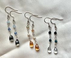 These cute teardrop glass dangling earrings make perfect gifts for the minimalist or if you are one yourself.  They add just a little flair to your wardrobe.  Each teardrop earring is glass, the accent beads are made of genuine gemstone, czech firepolish beads or glass beads (see description per earring) -Sterling Silver fishook backing -Teardrop glass beads - Dark Blue, Light Blue, Orange -4mm sapphire beads -4mm czech firepolish beads -4mm pacific blue luster firepolish bead -4mm dark blue glass beads -4mm opaque cream glass beads -4mm transparent topaz glass beads -Total length 2 & 1/4" Sapphire Beads, Drop Earrings Silver, Jewelry Care Instructions, Pacific Blue, Dangling Earrings, Czech Glass Beads, Earrings Silver, Teardrop Earrings, Blue Light