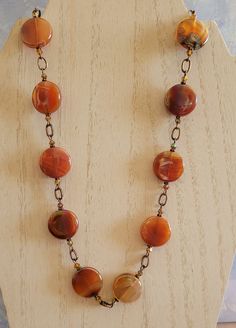 I fell in love the with rainbow hues in these coin shaped Carnelian beads.  In the sun, the colors just glow!  I've paired them with copper chain links and a copper toggle clasp.  I've also paired these beads with matching 2x ab Carnelian bicone crystals.  This necklace measures approximately 20 inches. Orange Gemstone Beads Round Jewelry, Orange Round Gemstone Bead Jewelry, Orange Round Gemstone Beads Jewelry, Handmade Orange Beads For Jewelry Making, Bohemian Carnelian Beaded Necklaces, Bohemian Round Carnelian Beaded Necklaces, Polished Round Carnelian Beads Jewelry, Bohemian Amber Round Beads, Gems, And Cabochons, Bohemian Amber Round Beads And Cabochons