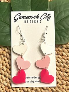 "FREE SHIPPING! HEART DANGLES Color Choices: shown in red, hot pink, white, and pastel pink, BUT you may choose from any of my acrylic colors (see last listing pic) *Made to order from 1/8\" cast acrylic *Laser cut *Hardware color choices: gold, silver, bronze (shown) *There is a post on the back of the heart if you choose that option. *Each heart is about 0.55\" tall Please take a look at my other shop listings. I also sell wooden and acrylic cut and engraved items, ornaments, and vinyl decals. Earrings Hearts, Valentine Earrings, Valentines Earrings, Cast Acrylic, Big Earrings, Engraved Items, White Earrings, Gift For Wife, Acrylic Colors