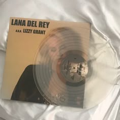 an old vinyl record sitting on top of a white sheet with the words lana del rey