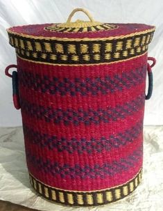 a red and black basket sitting on top of a table