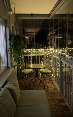 the balcony is decorated with string lights and furniture