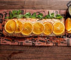 an image of fish with oranges and herbs on the side for garnish