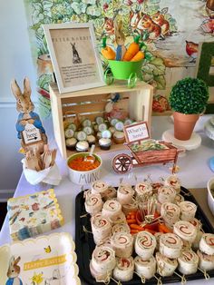 a table topped with lots of food and desserts