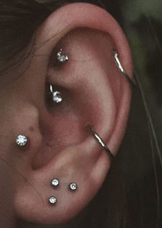 a person with some piercings on their ear