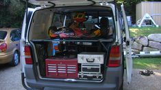 the back end of a van with skis and equipment in it