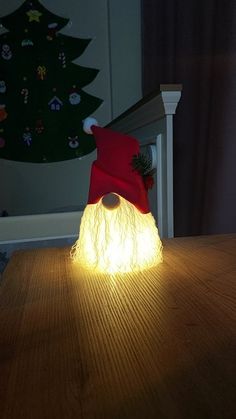 a light up santa hat sitting on top of a wooden table