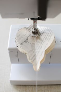 a piece of paper being sewn on to a sewing machine