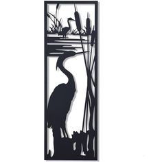 the silhouette of a heron standing in front of reeds and water with birds on it