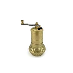 an antique brass oil burner with a metal handle and nozzles on a white background