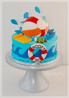 a birthday cake decorated with an image of a beach ball and life preserver on top