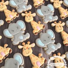 decorated cookies with giraffes and elephants on a table