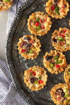 small tarts with various toppings on a plate