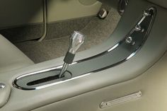 the interior of a car with a toothbrush holder in the center console and door handle