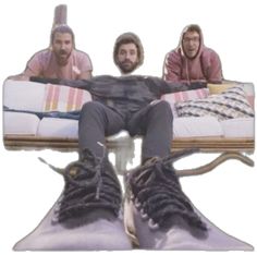 two men sitting on couches with their feet up in the air and one is wearing sneakers