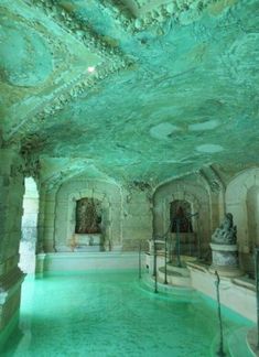 an indoor swimming pool is shown in this photo, with green paint on the walls and ceiling