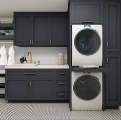 a washer and dryer in a kitchen with black cabinets, white counter tops