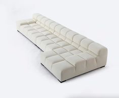 a white couch sitting on top of a white floor