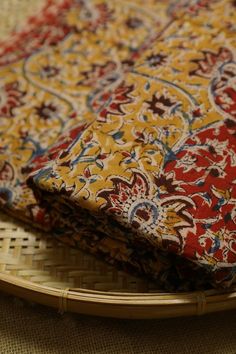 two pieces of cloth sitting on top of a bamboo tray