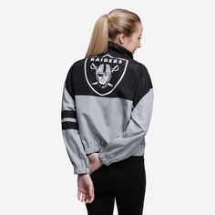 This Las Vegas Raiders Women's Winning Play Windbreaker has a bold team logo on the back, so you can show off your team spirit to everyone you leave in the dust while you run the track. Features All-over team-colored design so you can rep the team in style Team logo display on upper left chest, in case there were any doubts where your allegiances lie Bold team logo display on reverse side for an additional dose of awesome Left arm stripes Half-zip structure Long sleeves, so you can fan on even i Athleisure Activewear For Sports Events With Team Logo, Black Activewear For Training With Team Name, Sporty Activewear For Sports Season, Varsity Track Jacket In Team Colors For Sports, Black Team Spirit Activewear For Training, Varsity Style Track Jacket In Team Colors For Sports, Athletic Heather Activewear For Sports Season, Black Athleisure Activewear For Team Events, Moisture-wicking Team-colored Activewear For Sports