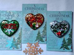 three christmas heart brooches sitting on top of each other