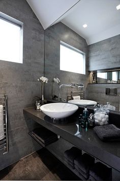 a large bathroom with two sinks and towels on the counter top in front of it