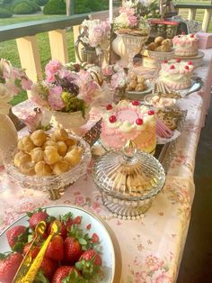 a table topped with lots of cakes and desserts