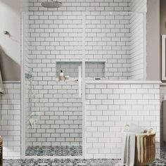 a bathroom with white tile and black and white floor tiles on the walls, shower stall door, and towel rack