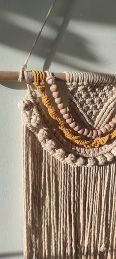 a macrame hanging on a wall with rope