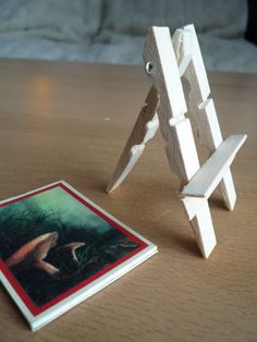 there is a small wooden easel next to a card holder