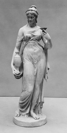 a statue of a woman holding a vase