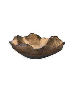 a wooden bowl sitting on top of a white surface