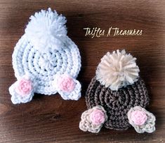 two crocheted hats sitting on top of a wooden table