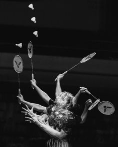 two women are playing badminton with each other