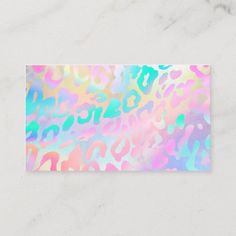 a business card with an abstract design in pastel pink, blue and green colors