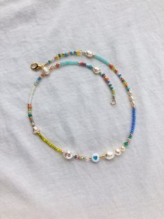 Rainbow beaded necklace is handmade from the best materials. You can buy it as a gift for a friend, sister, mother. BEADS SIZE : The pearls are 3-9mm (0.11 - 0.35 inch), and the beads are 2-4mm (0.07 - 0.13 inch). The LENGHT: The length is adjustable. You can choose your size. If you need a custom size feel free to write, I'll make a custom size choker for you. IMPORTANT: A chain is added to each choker for additional control. IMPORTANT INFORMATION: *Created in a pet-free and smoke-free home. * Y2k Necklace, Real Pearl Necklace, Indie Jewelry, Beaded Necklace Designs, Beaded Necklace Diy, Rainbow Necklace, Rainbow Beads, Necklace Heart, Seed Bead Necklace