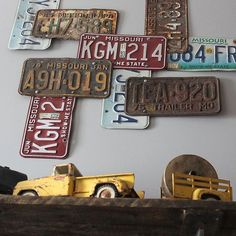 a collection of license plates mounted to the wall