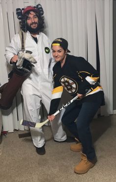 two people dressed as hockey players posing for a photo